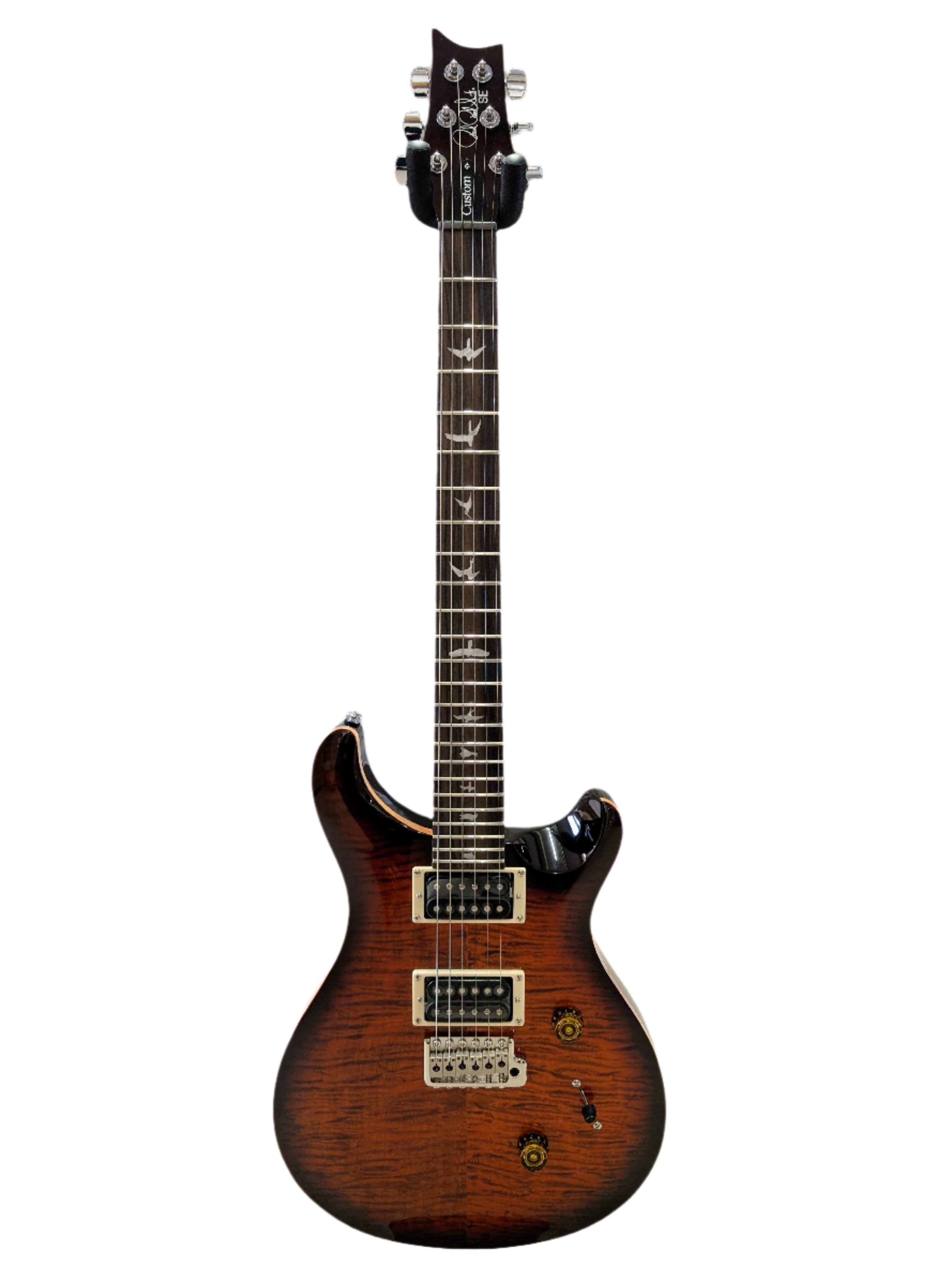 Brown sunburst electric guitar with two humbucker pickups, bird inlays on the fretboard, and gold control knobs.