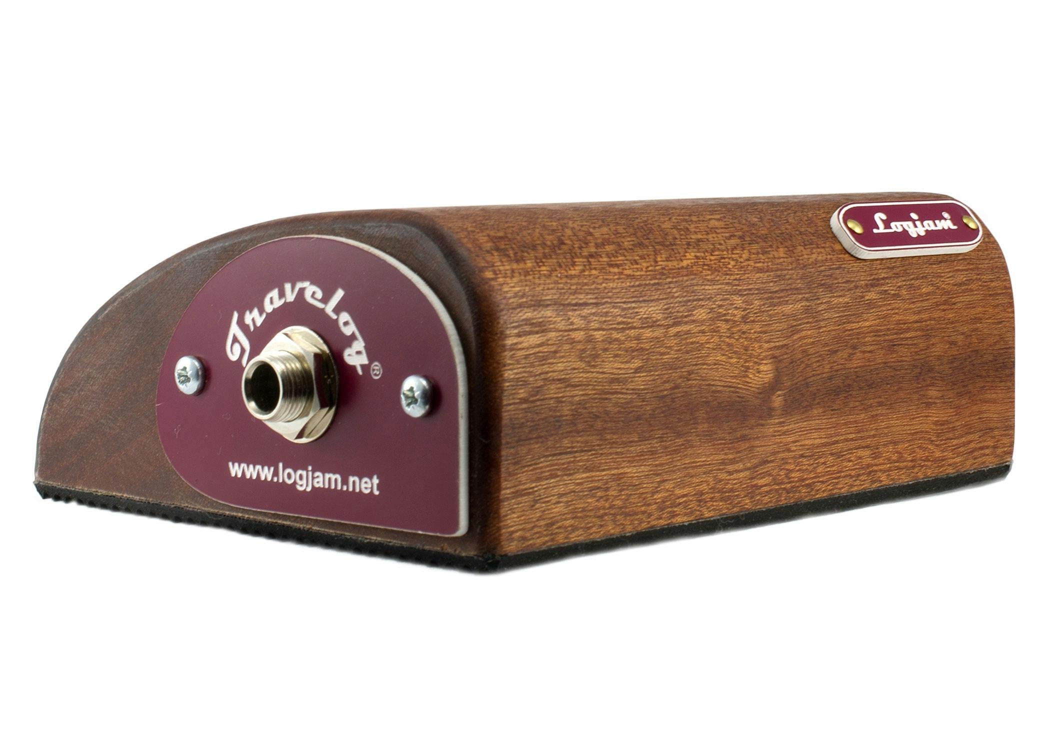 Logjam Travelog percussion stompbox made of brown wood, with a metal input jack and maroon label on one end for connecting to audio equipment.