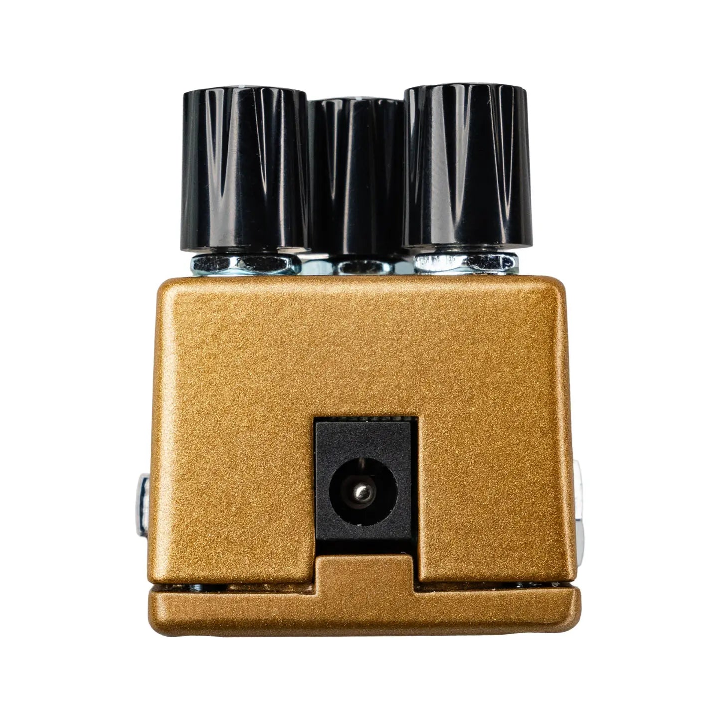 Gold rectangular guitar effects pedal accessory with three large black knobs on top and a power input jack in the center front.