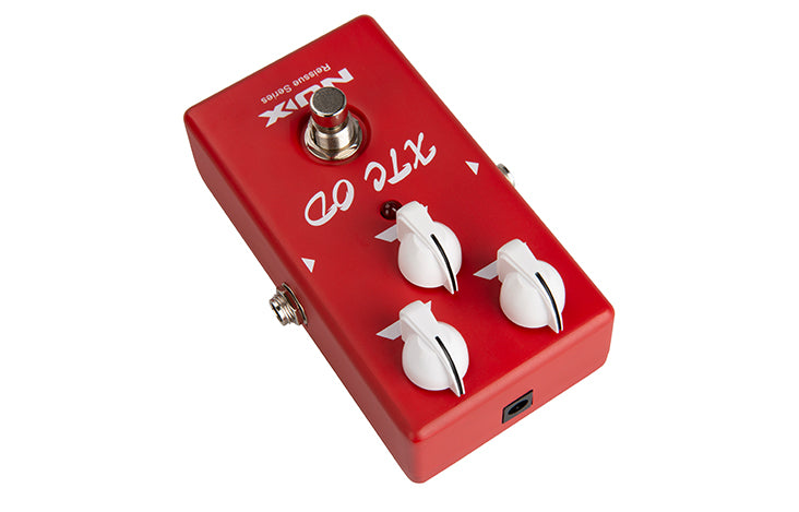 Red FX pedal with three white control knobs, a metal footswitch, side input jack, and "XTC OD" label on the top surface.