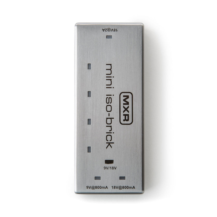 Slim silver MXR mini iso-brick FX pedal power supply with five output ports labeled for 9V and 18V, compact rectangular metal case.