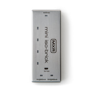 Slim silver MXR mini iso-brick FX pedal power supply with five output ports labeled for 9V and 18V, compact rectangular metal case.
