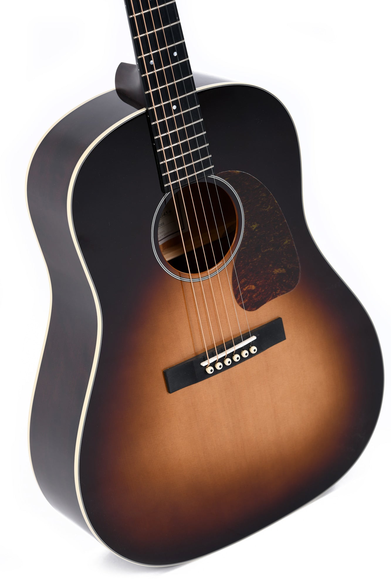 Steel-string acoustic guitar with a dark sunburst finish, cream binding, tortoiseshell pickguard, and six bridge pins.