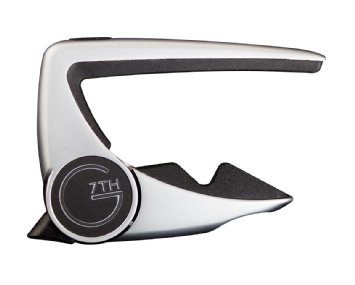 Silver guitar capo with a sleek, modern design and a black circular grip labeled "G 7TH" on the side.