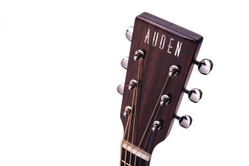 Dark wood acoustic guitar headstock with six silver tuning pegs and the word "AUDEN" in white letters on the front.