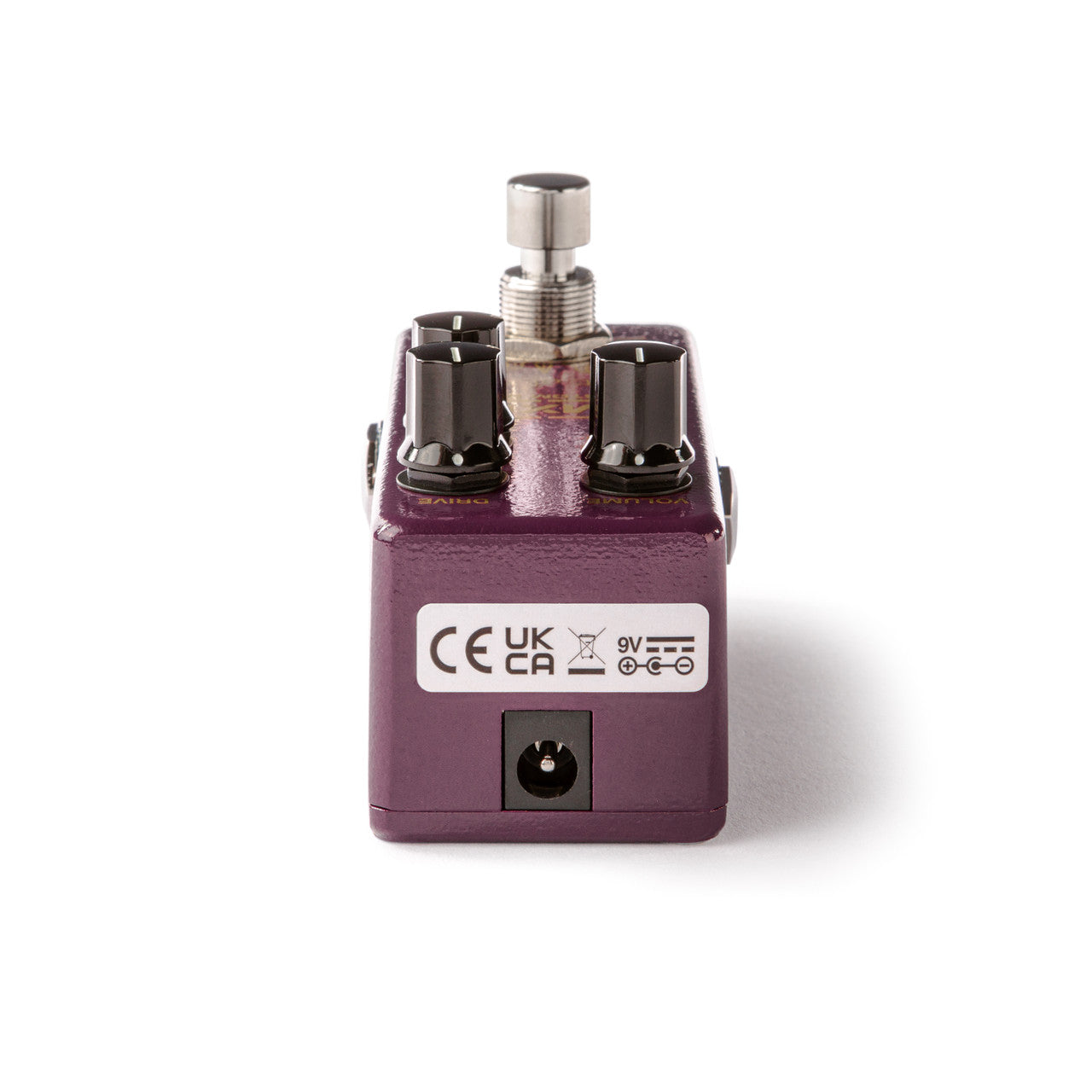 Compact purple effects pedal with three black control knobs, a silver footswitch on top, and a 9V power input on the front panel.