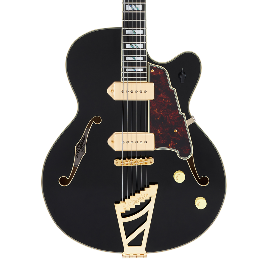Black electric guitar with gold hardware, two cream pickups, tortoiseshell pickguard, F-holes, and a distinctive angular gold tailpiece.