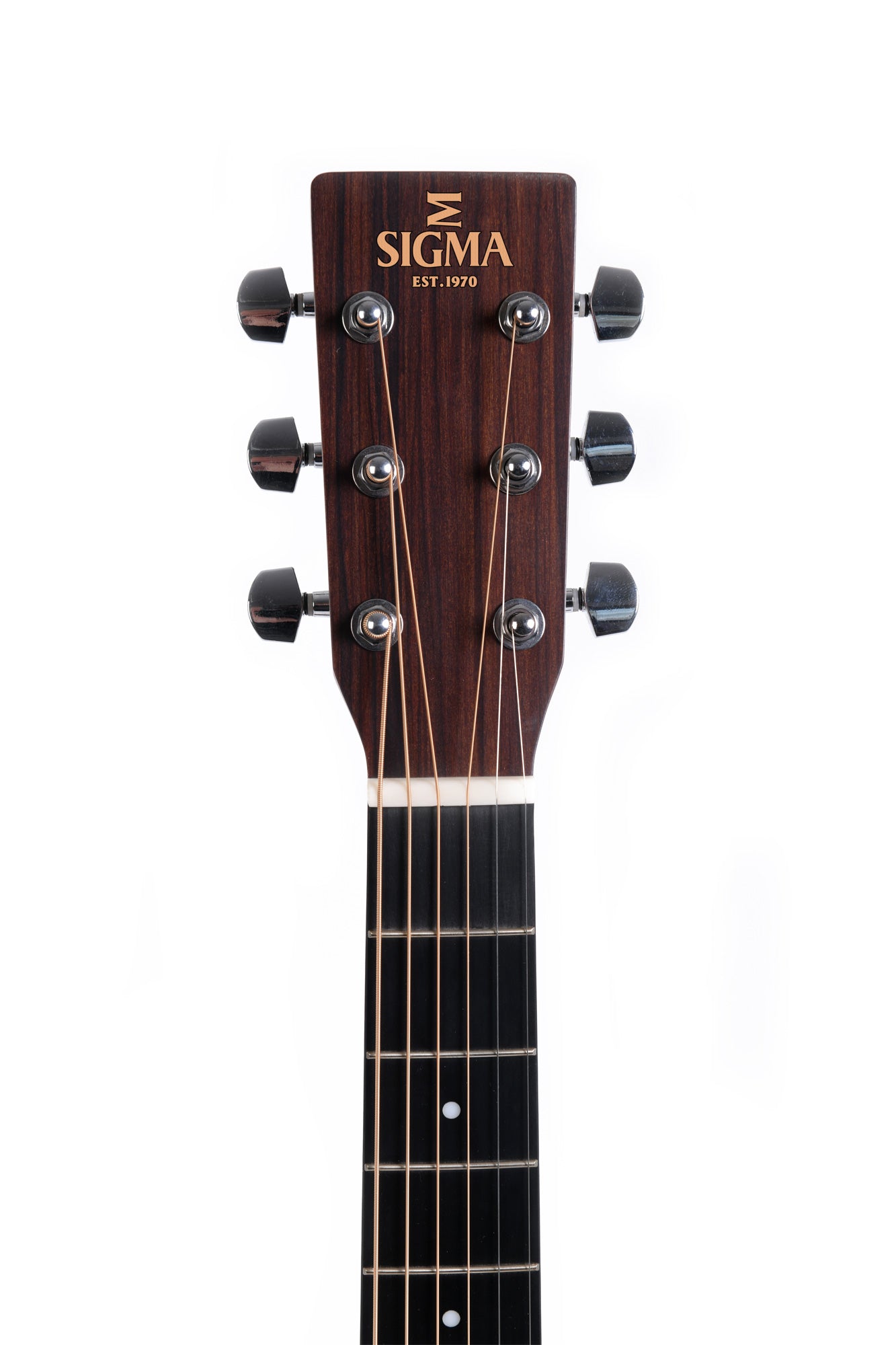 Close-up of a Sigma acoustic guitar headstock with six tuning pegs and gold "Sigma Est. 1970" logo above the nut and fretboard.