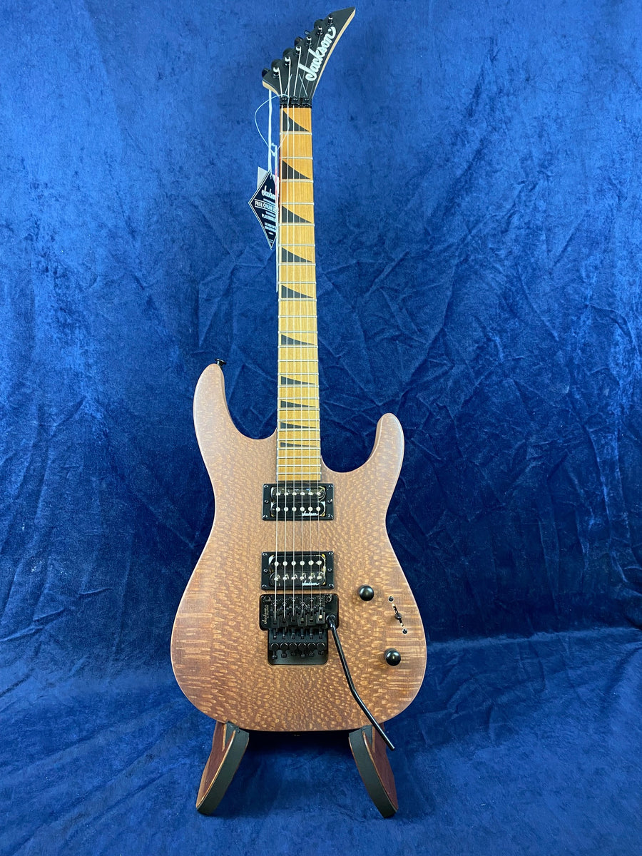 Quilted maple top electric guitar with a light brown finish, two humbucker pickups, black hardware, and a maple neck featuring sharp triangle inlays.