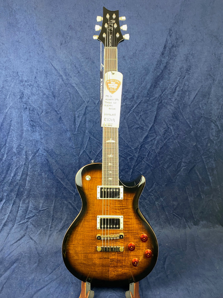 Sunburst finish electric guitar with two humbucker pickups, four amber control knobs, chrome hardware, and a PRS headstock; price tag attached.