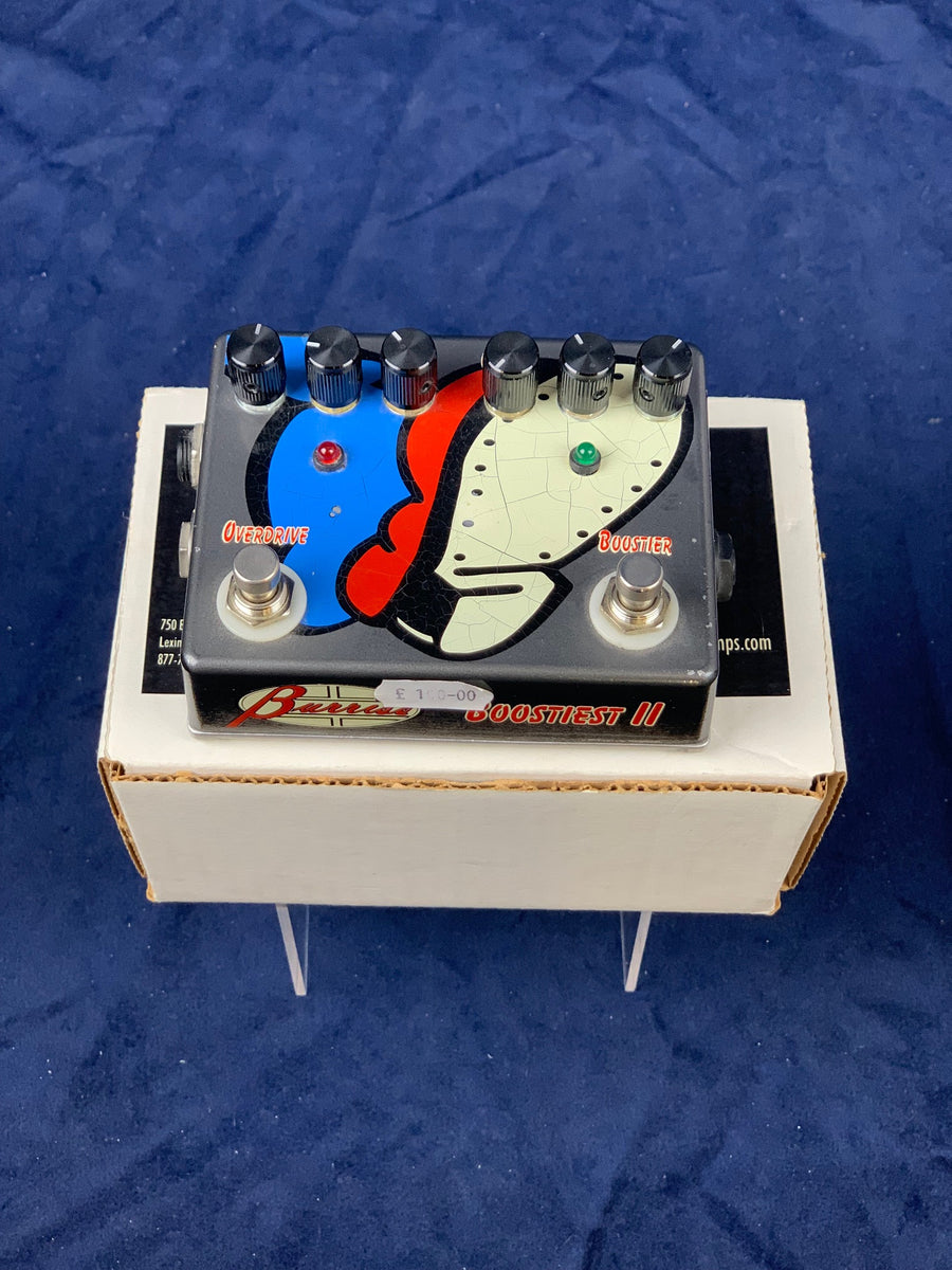 Guitar FX pedal labeled “Boostiest II” with colorful face design, six control knobs, two footswitches, and indicator LEDs, placed on a white box.