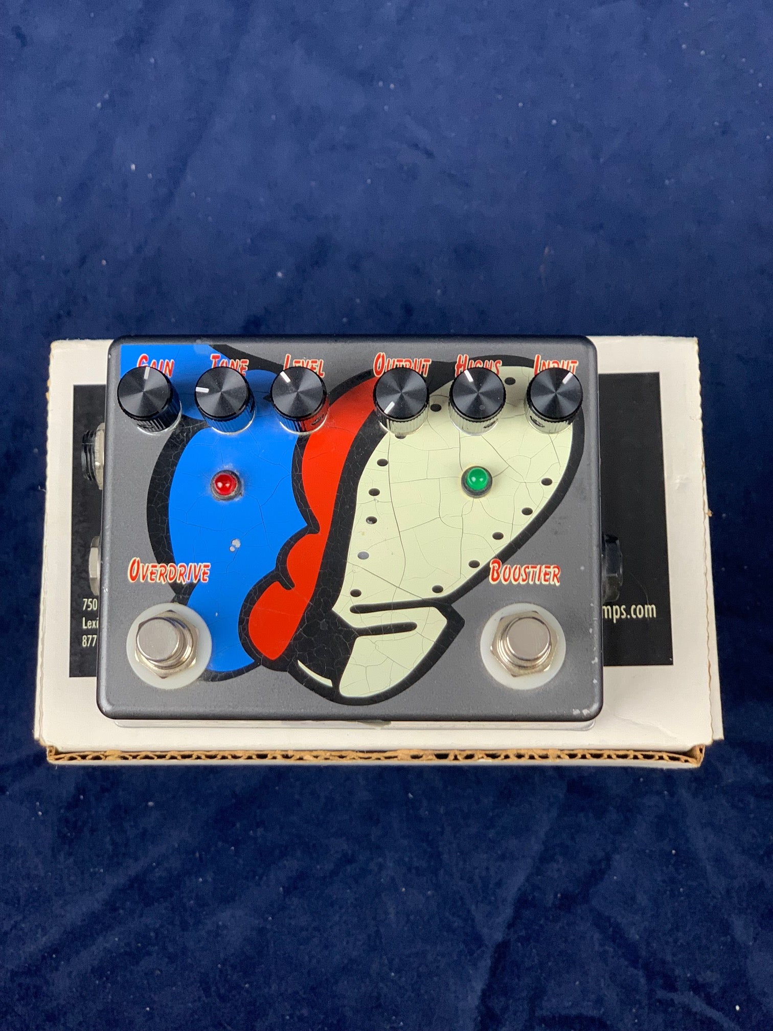 FX pedal with two footswitches, six knobs, and a colorful split-face graphic; labeled Overdrive on the left and Booster on the right.