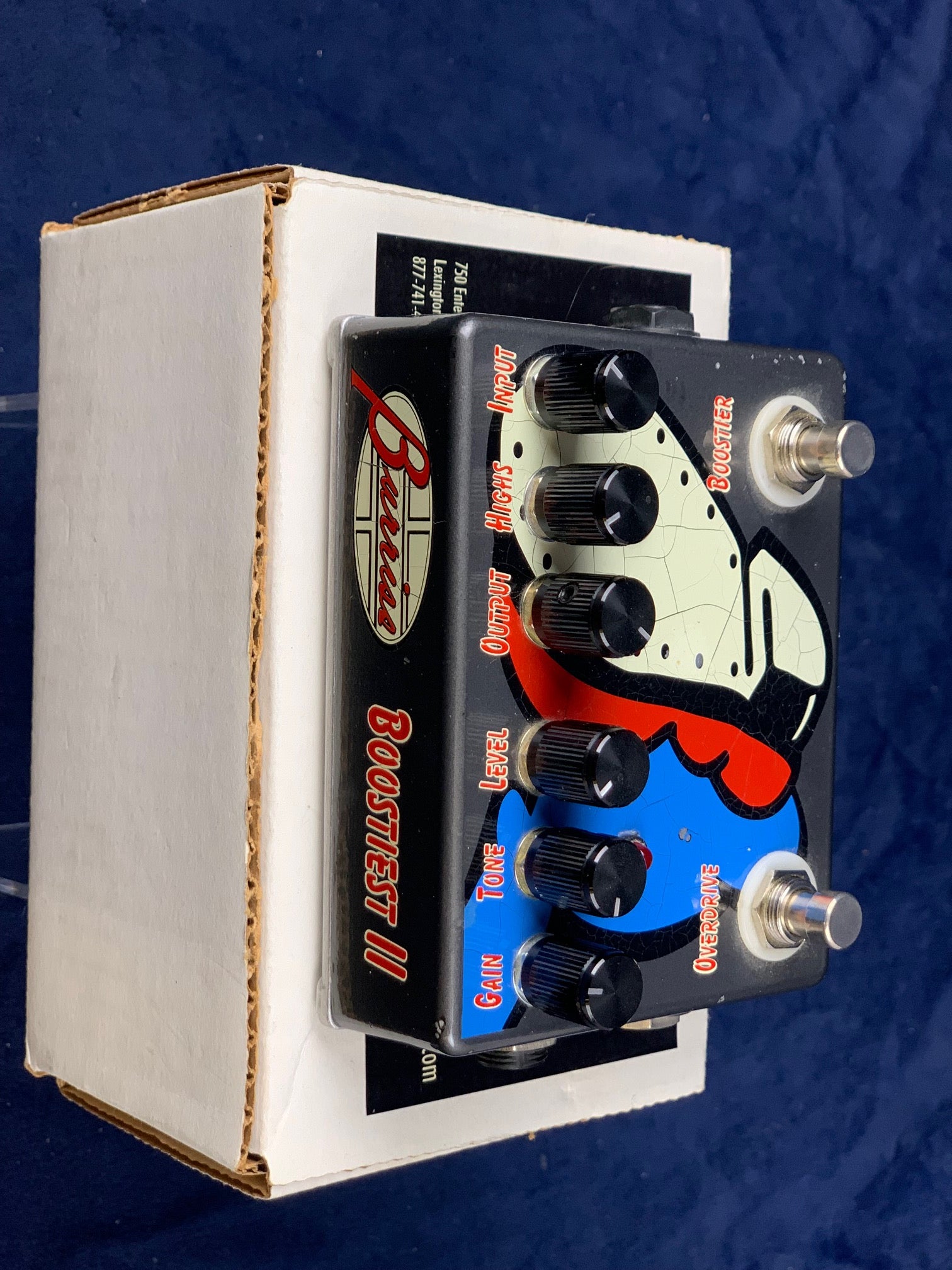 Burriss Boostest II FX pedal with six black knobs, two footswitches, and colorful faceplate art in red, blue, and cream.