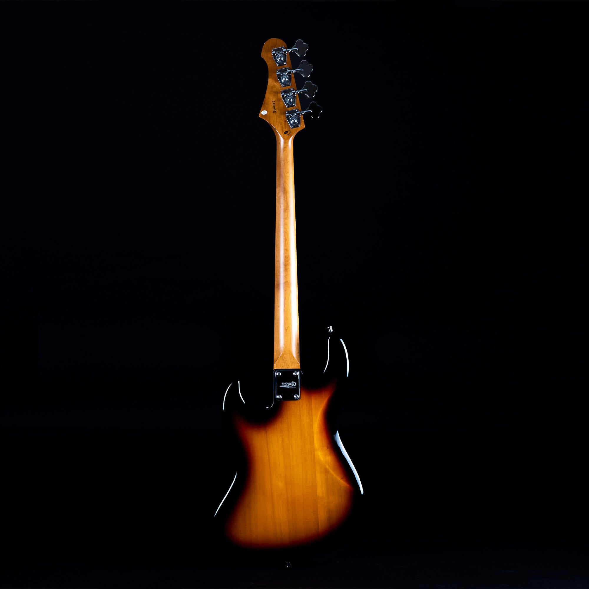 Sunburst finish bass guitar shown from the back, highlighting the wooden neck and tuning pegs against a black background.