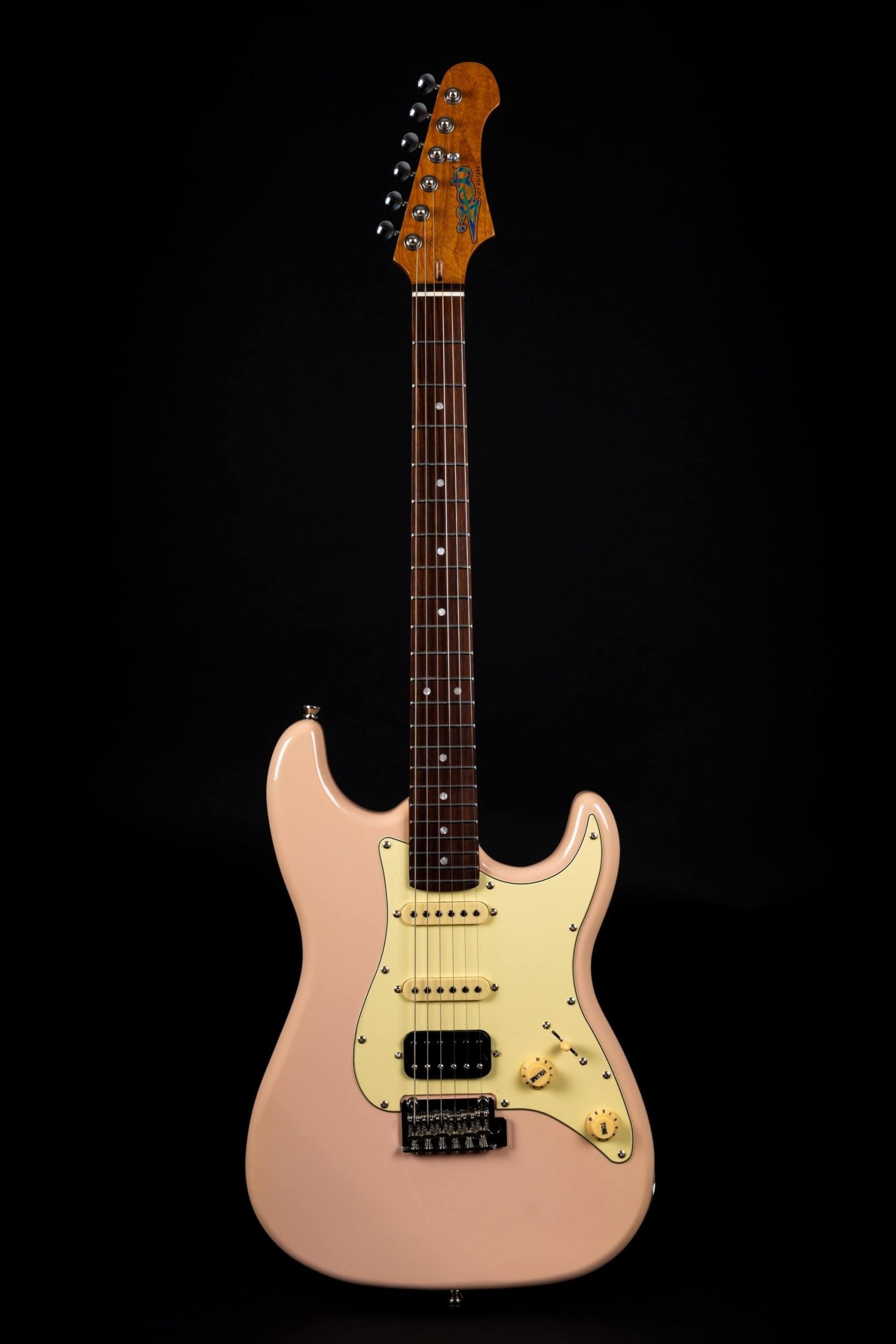 Light pink electric guitar with cream pickguard, three pickups, two control knobs, and a dark wood fretboard.