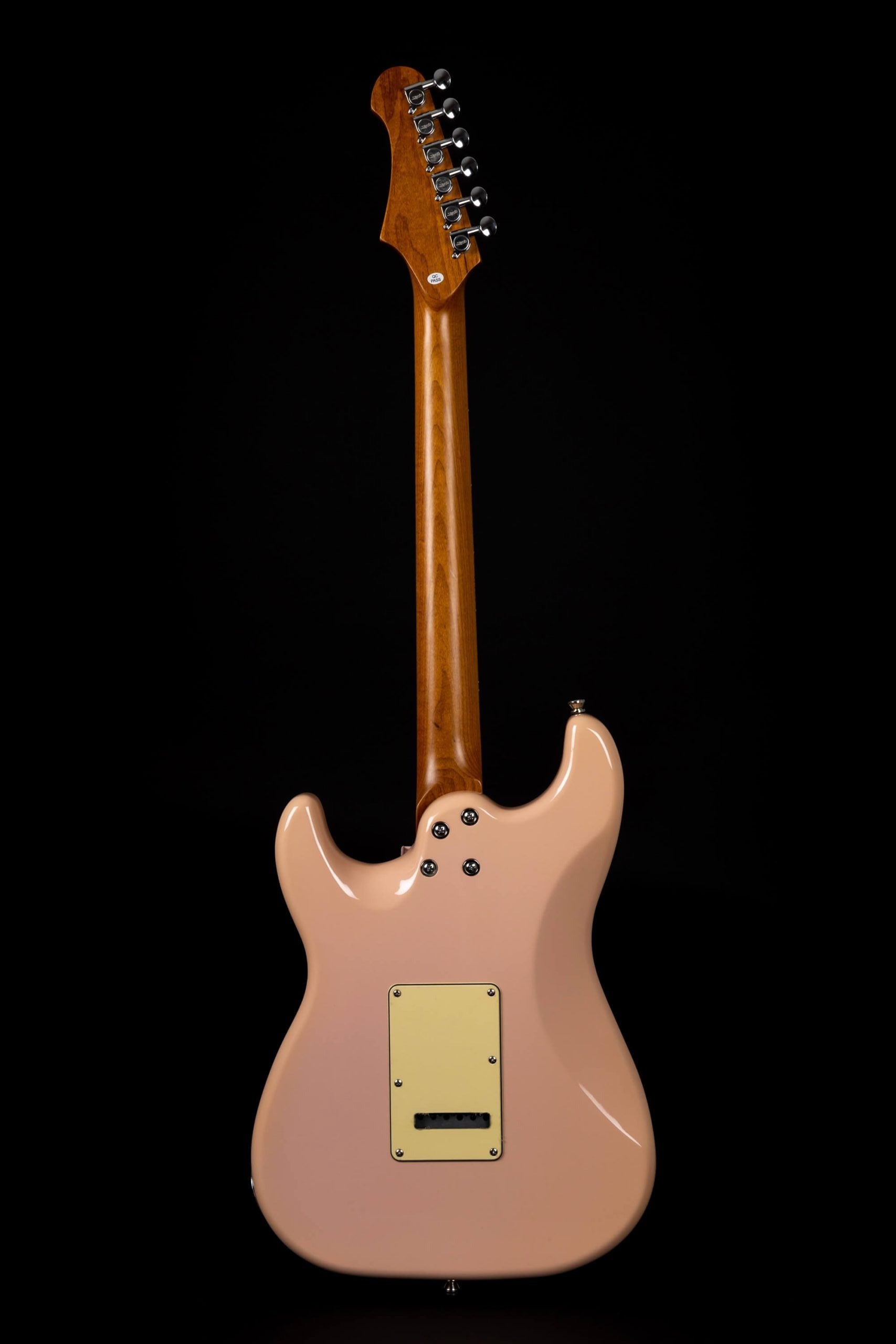 Electric guitar shown from the back, with a natural wood neck and glossy pale pink body featuring a cream-colored electronics cover plate.