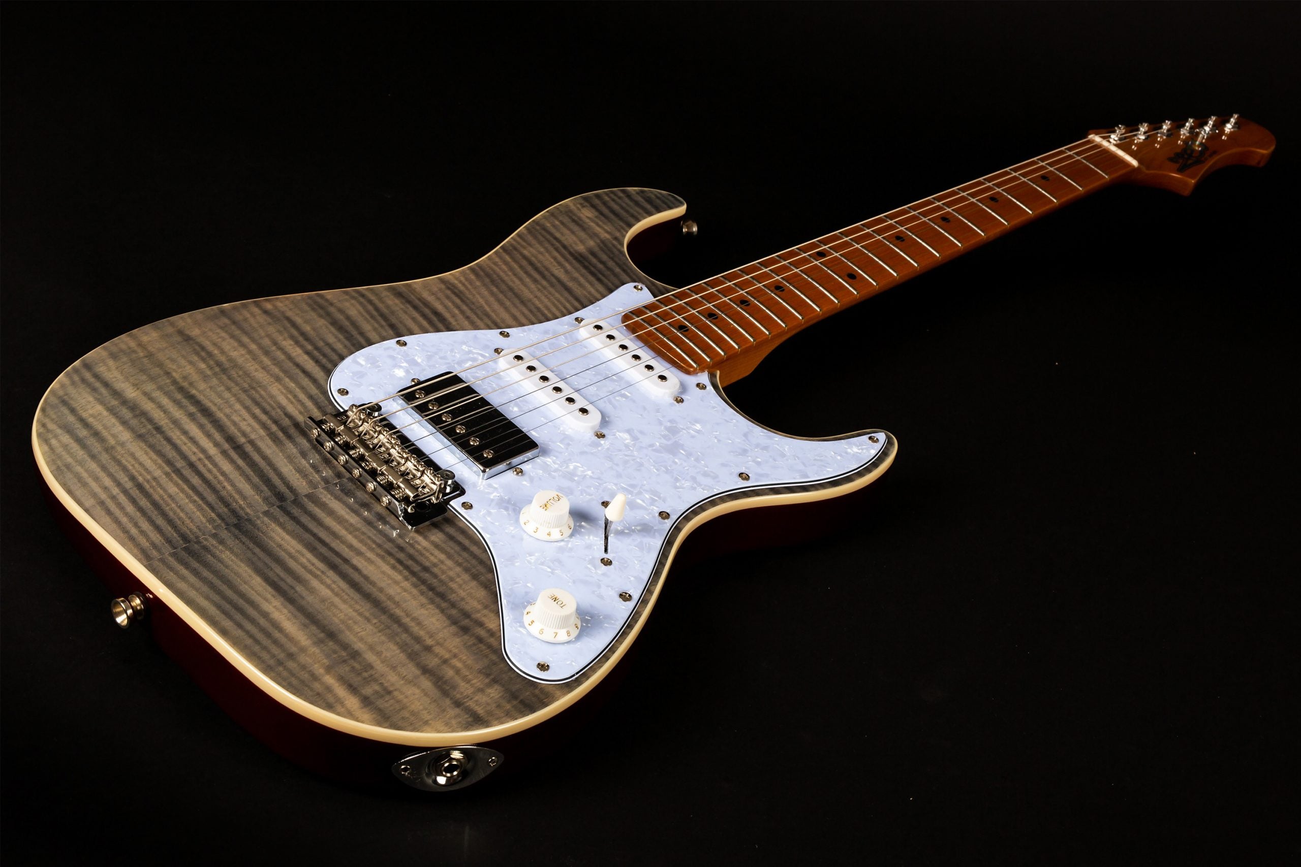 Electric guitar with a gray flamed maple top, light blue pearloid pickguard, three pickups, and a maple neck with dot inlays.