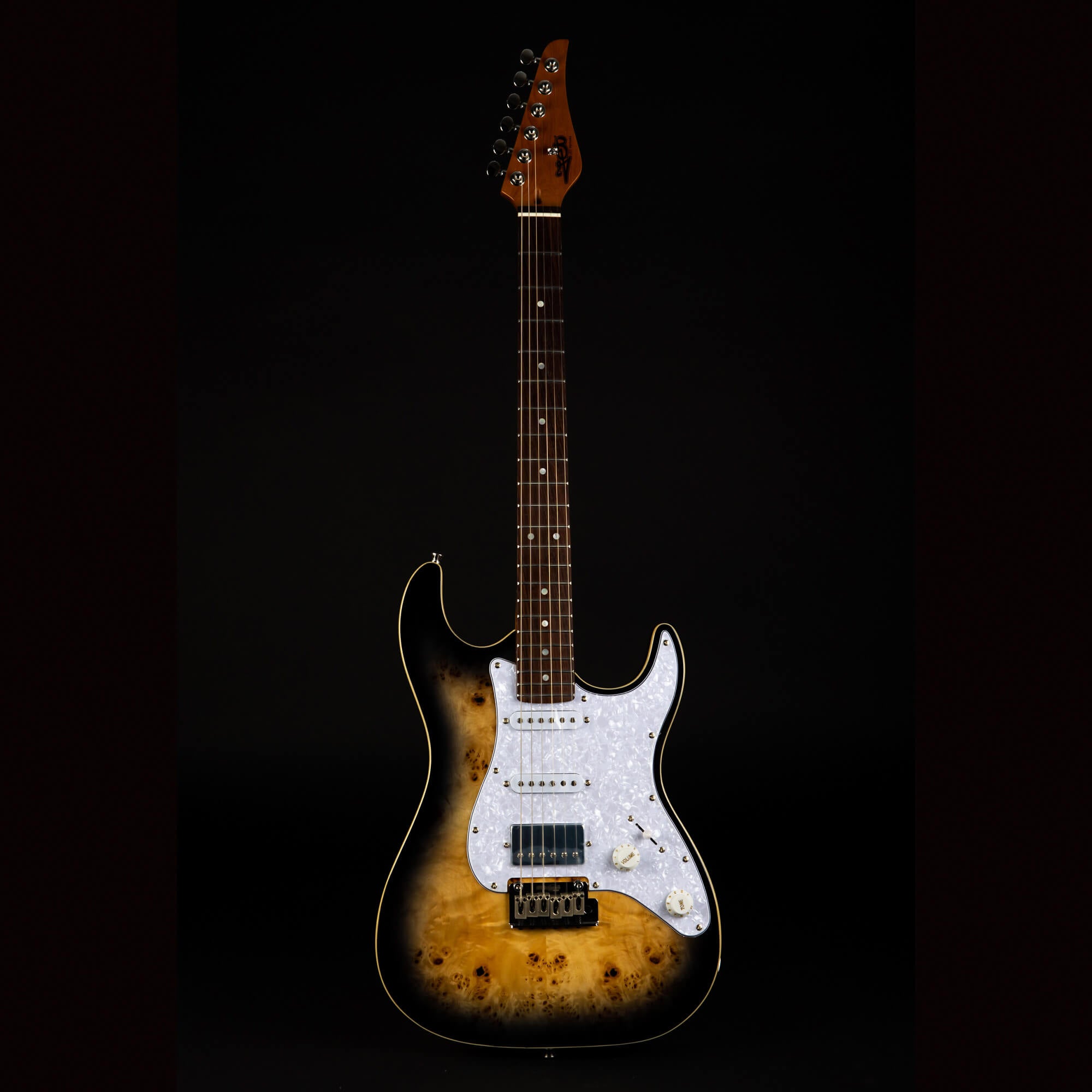 Sunburst electric guitar with a white pearloid pickguard, six strings, and a dark wood neck against a black background.