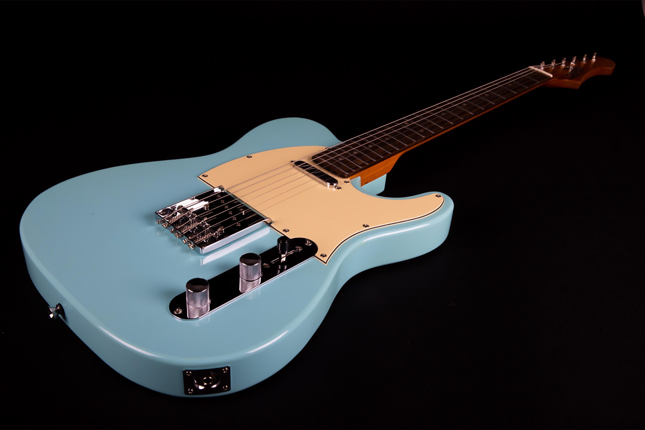 Light blue electric guitar with a cream pickguard, chrome hardware, two control knobs, and a dark fretboard on a black background.
