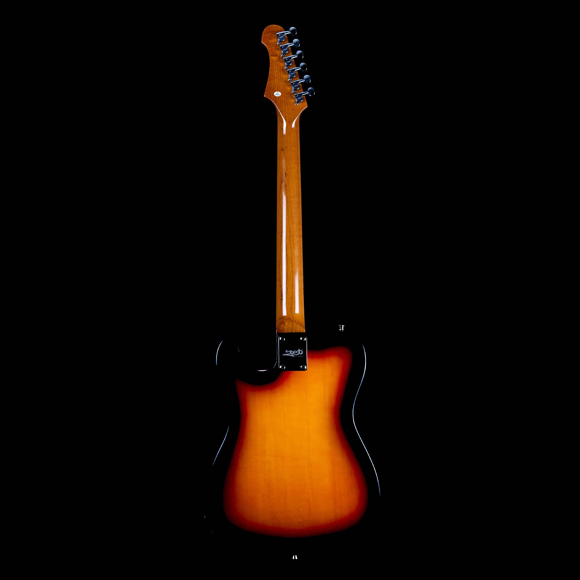 The back of a sunburst electric guitar with a glossy wooden neck, chrome tuners, and a black-bordered yellow-orange body against a black background.