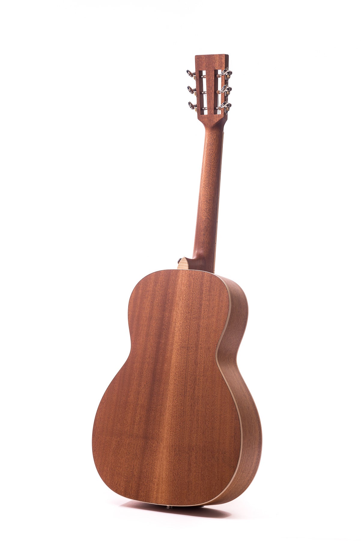 Mahogany acoustic guitar shown from the back, highlighting smooth wood grain, rounded body, and the neck with exposed tuning pegs.