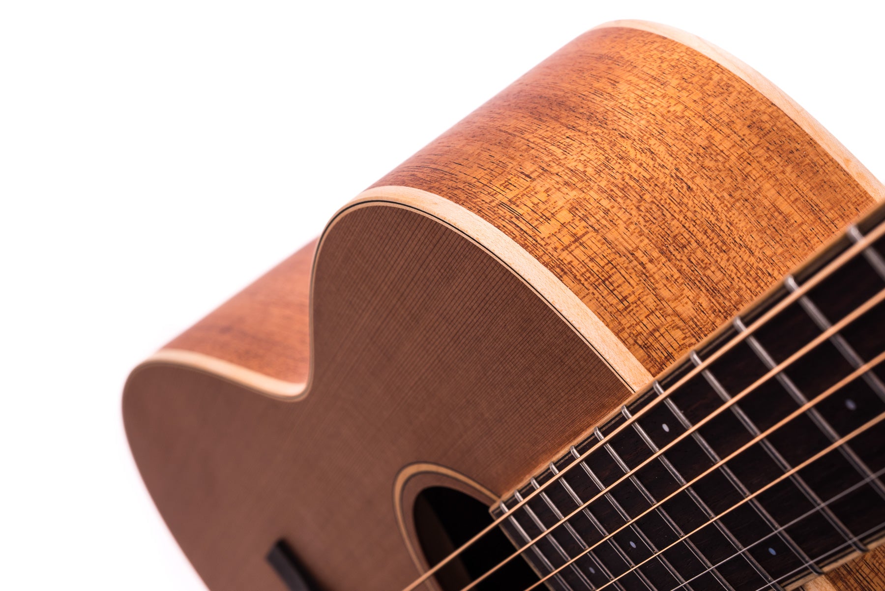 Glossy acoustic guitar with natural wood grain, smooth curves, and close-up view of the strings, soundhole, and fingerboard.
