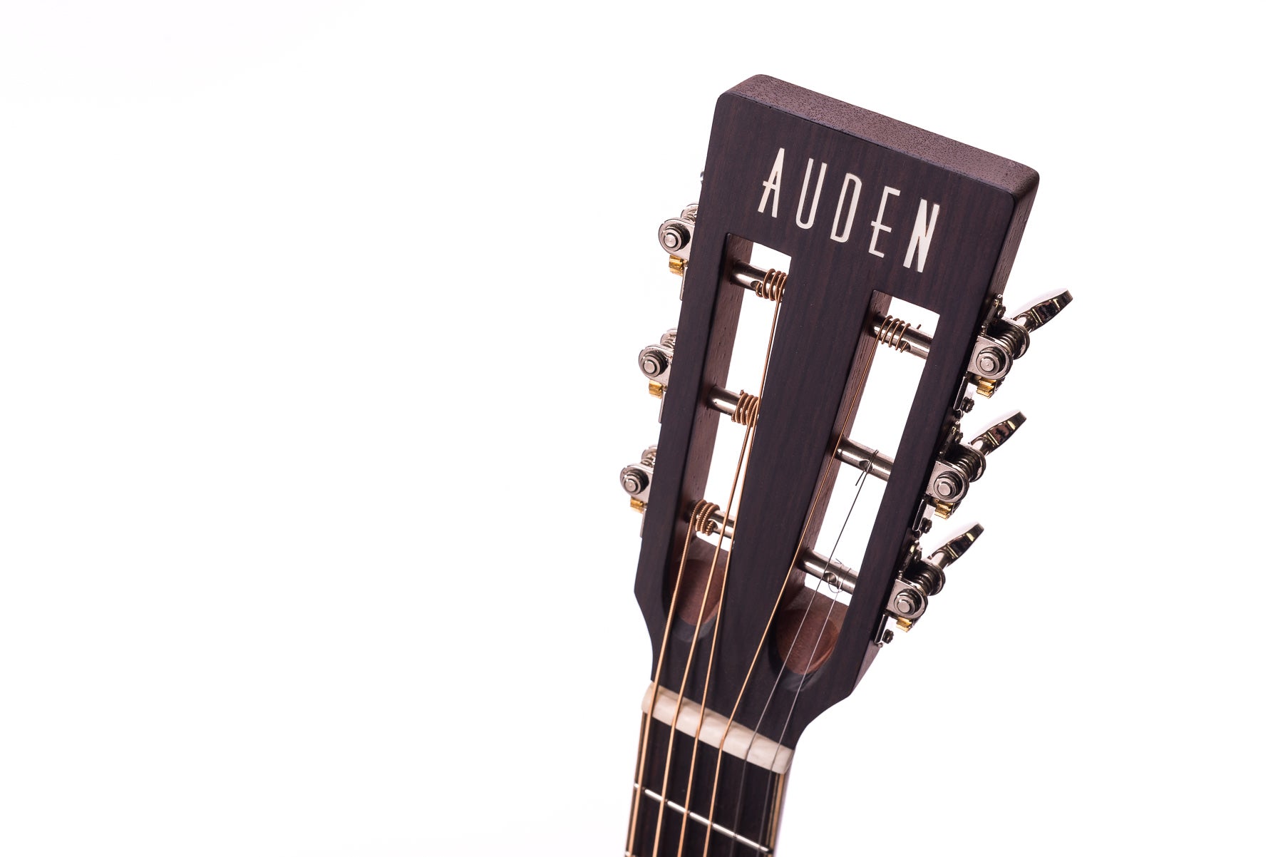 Dark wood acoustic guitar headstock with open slot design, six tuning pegs, and "AUDEN" inlay on the face.