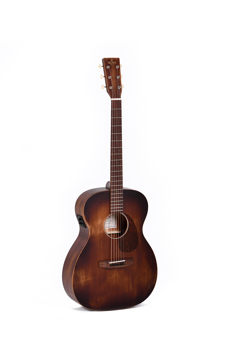 Dark brown acoustic guitar with a matte finish, six strings, and a rounded body. The brand "Sigma" is printed in gold on the headstock.