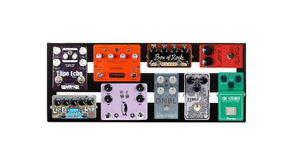 A rectangular pedalboard holds nine colorful guitar effect pedals, each with knobs and footswitches, arranged neatly in rows.