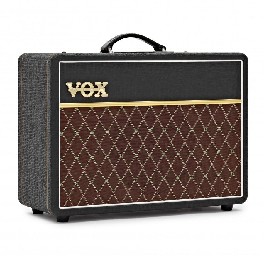 Black Vox amplifier with gold logo, a black handle on top, and a brown front grille featuring a diamond pattern with gold and cream lines.
