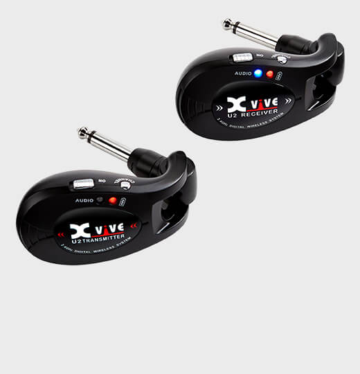 Two black Xvive U2 wireless transmitters, each with a 1/4-inch plug, labeled as transmitter and receiver with LED indicators and switches.
