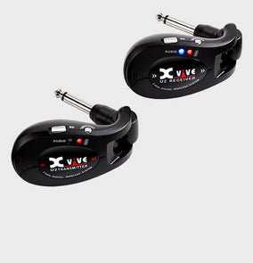 Two black Xvive U2 wireless transmitters, each with a 1/4-inch plug, labeled as transmitter and receiver with LED indicators and switches.