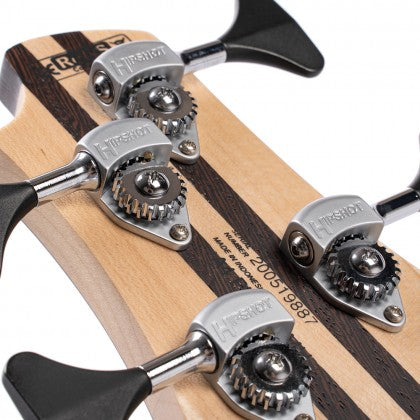 Close-up of four metal tuning pegs and gears on the headstock of a bass guitar with visible wood grain and serial number.
