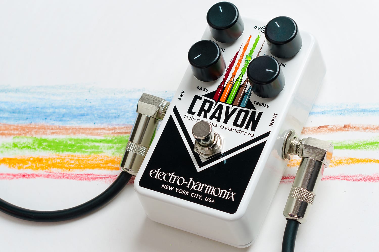 Electro-Harmonix Crayon effects pedal with four knobs, colorful crayon graphic, and patch cables connected; crayon lines drawn underneath.
