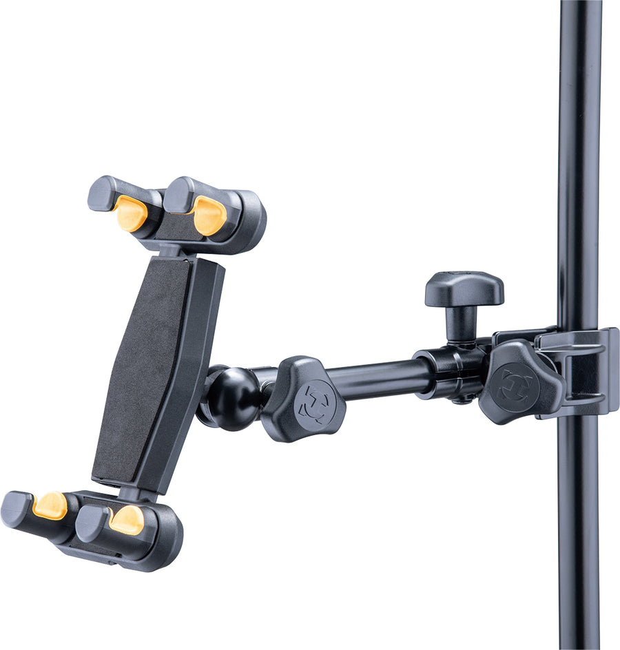 Adjustable black mount for iPhone and tablet, featuring yellow grips and clamp, attached to a vertical metal pole with locking knobs.