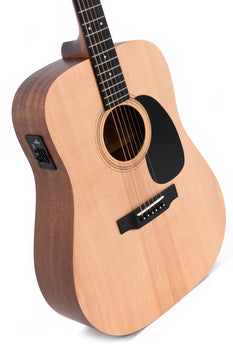 Light wood acoustic guitar with black pickguard, electronic control panel on the side, six strings, and a round sound hole.