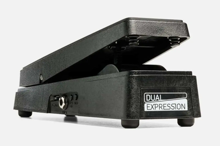 Black effects pedal with a slanted treadle labeled "Dual Expression," features jack input, toggle switches, and four rubber feet.