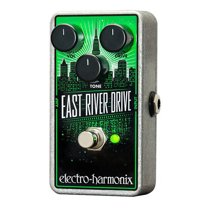 Electro-Harmonix East River Drive effects pedal, metallic box with three black knobs labeled Vol, Drive, Tone, city skyline graphic, footswitch, green LED.