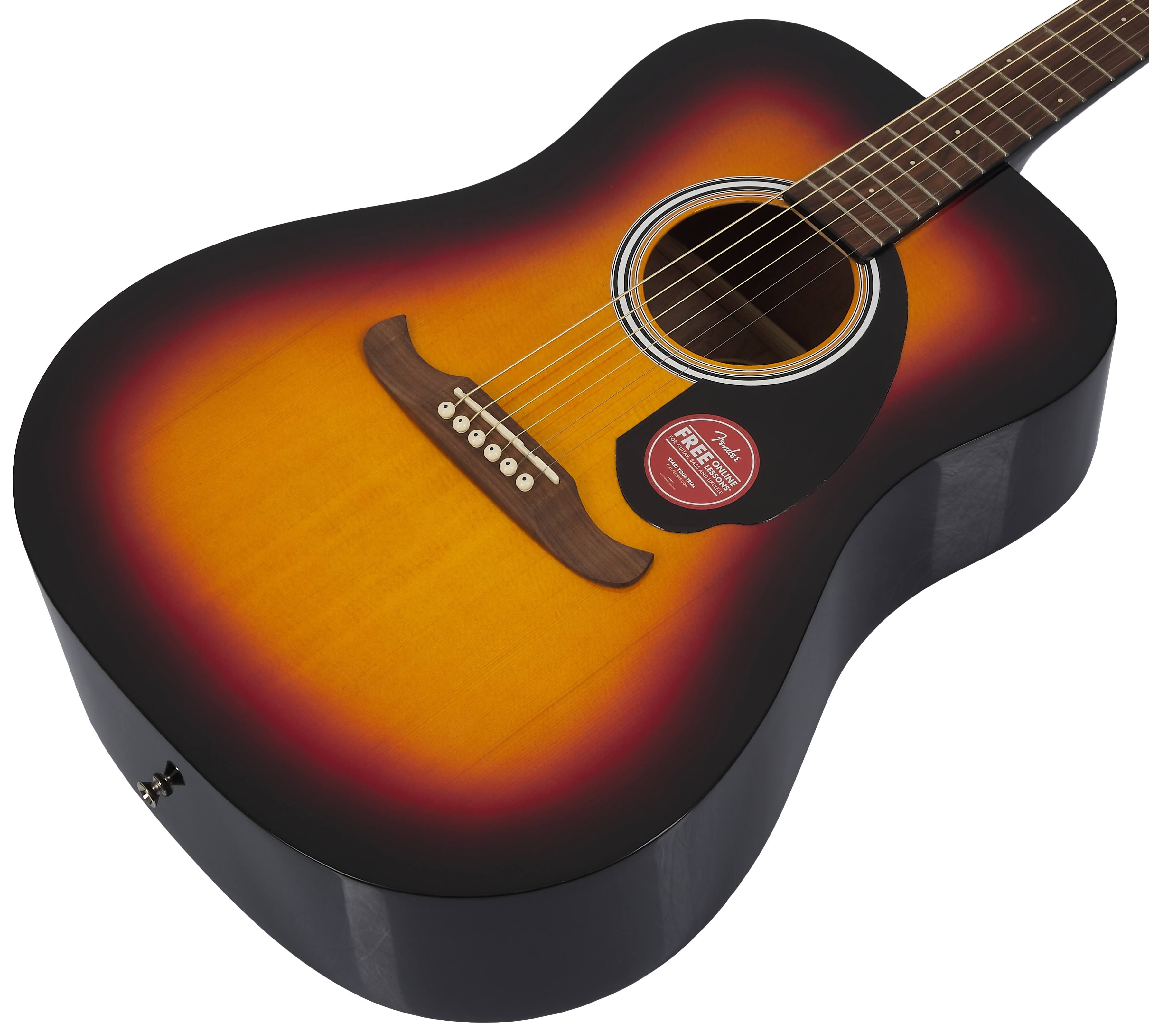 Acoustic guitar with a sunburst finish, dark edges fading to yellow center, six strings, a wooden bridge, and a round sound hole with a sticker.