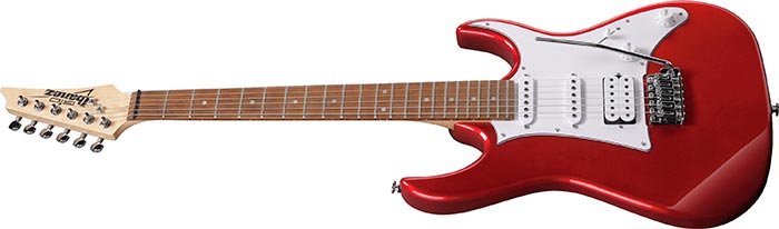 Red electric guitar with a white pickguard, two humbucker pickups, one single-coil pickup, and a tremolo bridge.
