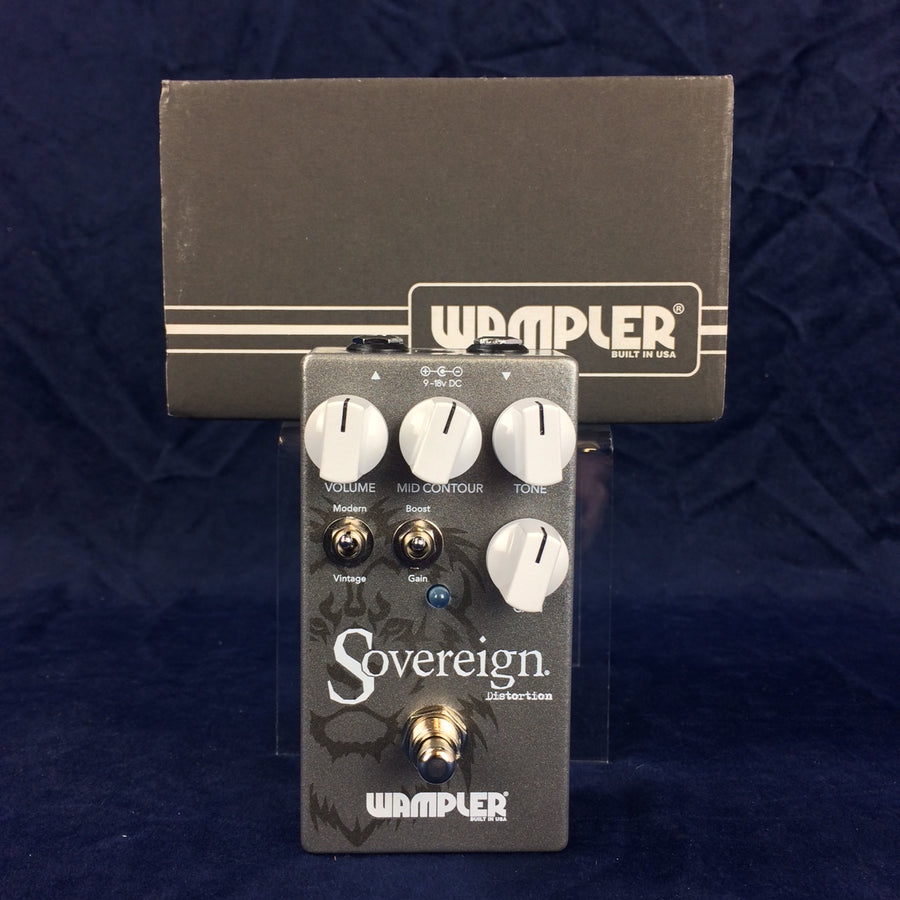 Wampler Sovereign Distortion effects pedal with four white knobs, two toggle switches, a footswitch, and a grey box behind it.