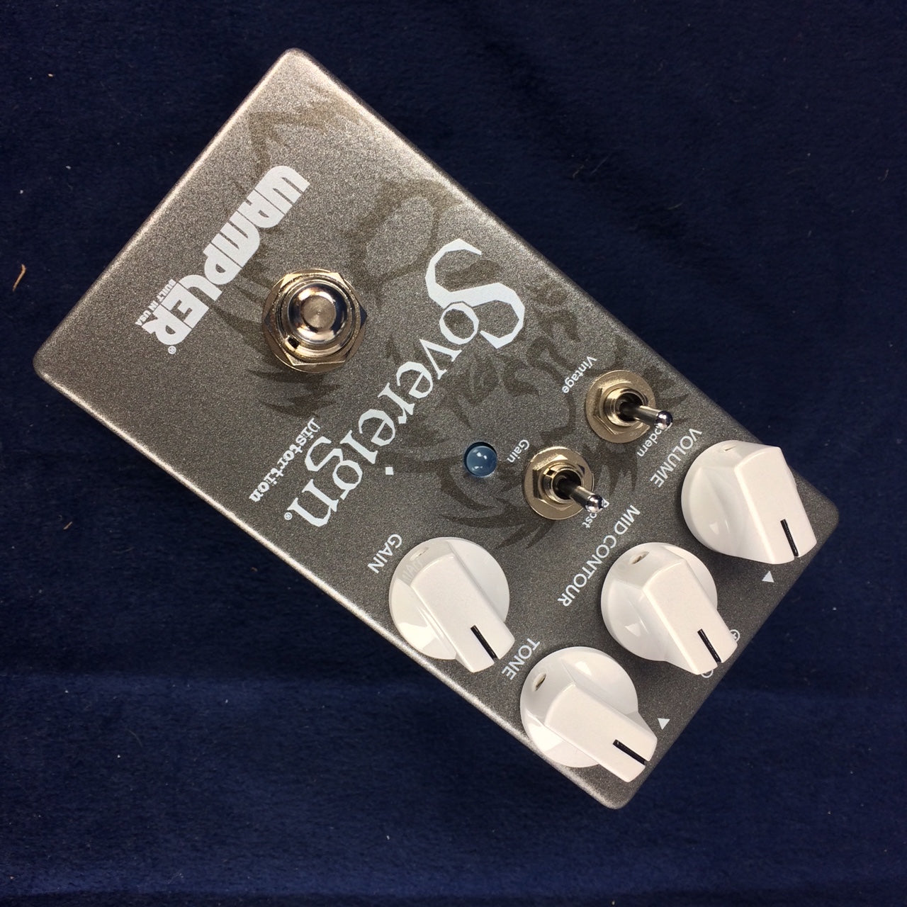 Sovereign distortion effects pedal with four white knobs, two toggle switches, a blue LED, and a metal footswitch on a dark surface.