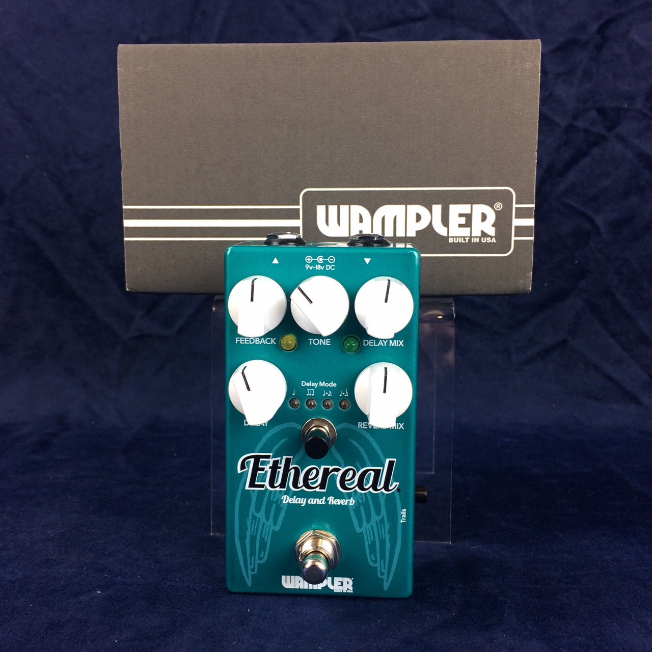 Teal Wampler Ethereal Delay and Reverb guitar pedal with five white knobs, footswitch, and labeled controls, set against a box with the Wampler logo.