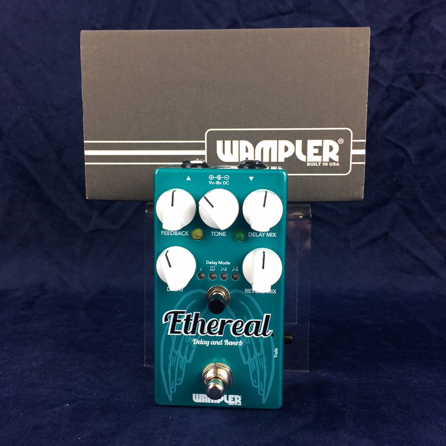 Teal Wampler Ethereal Delay and Reverb guitar pedal with five white knobs, footswitch, and labeled controls, set against a box with the Wampler logo.
