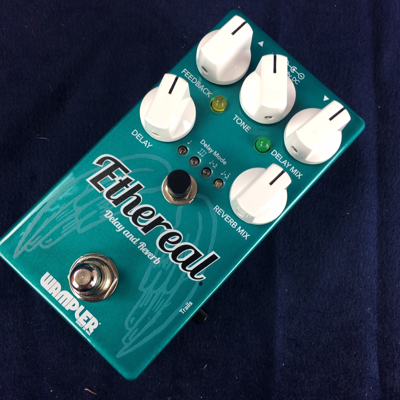 Teal Wampler Ethereal Delay and Reverb guitar effects pedal with five white knobs, labeled switches, and footswitch on a dark surface.