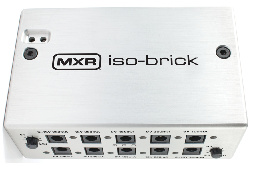 Silver MXR iso-brick effects pedal power supply with multiple labeled output jacks and two black control knobs on opposite sides.