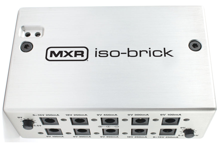 Silver MXR iso-brick effects pedal power supply with multiple labeled output jacks and two black control knobs on opposite sides.
