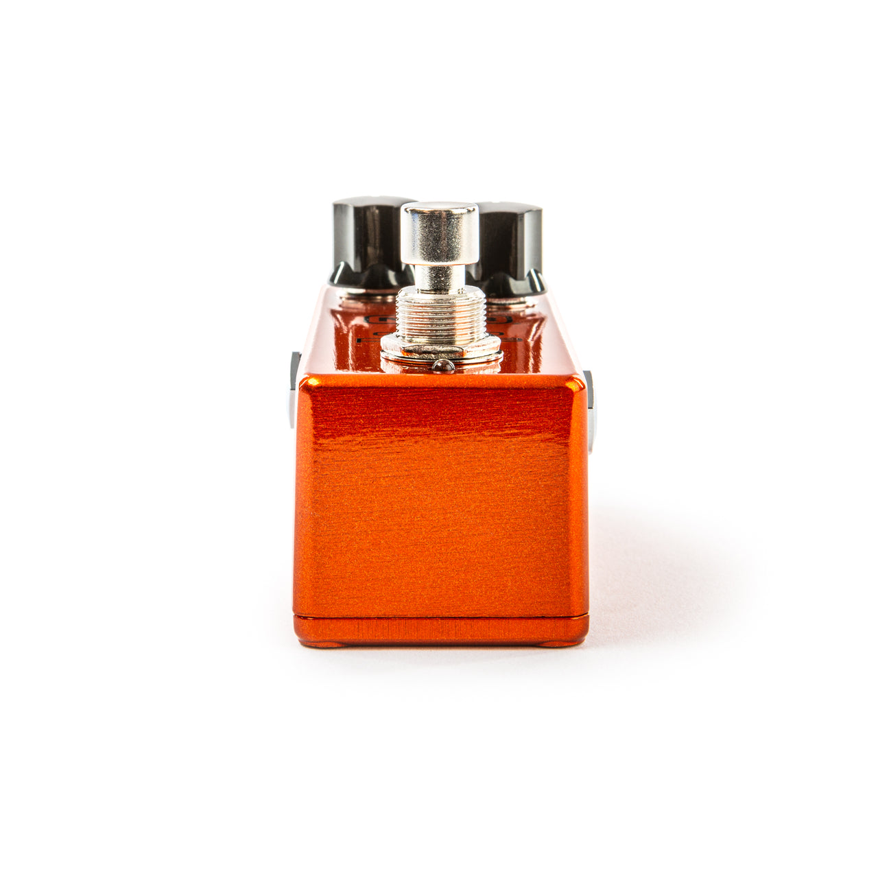Metallic orange FX pedal with a single footswitch on top and black control knobs visible at the back.