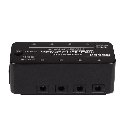 Rectangular black effects pedal power supply with four DC output jacks on one side and labeled input and output ports on the top surface.