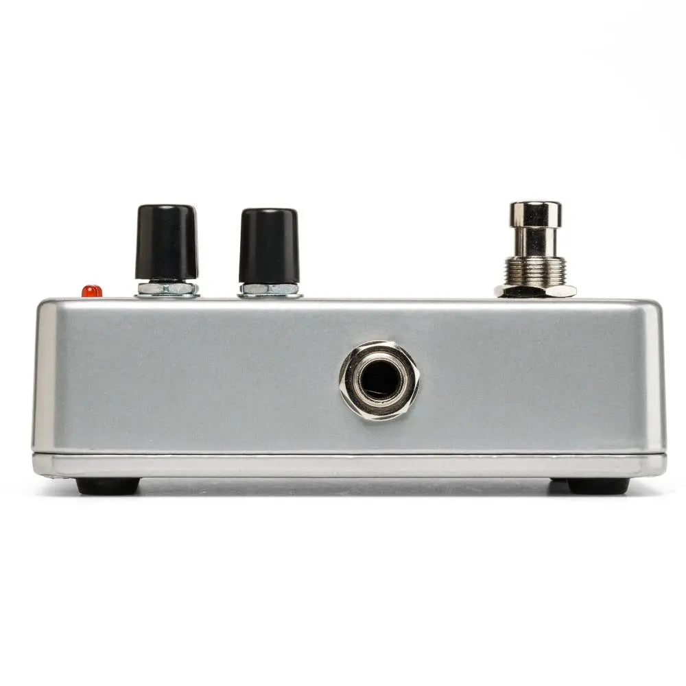 Silver effects pedal with two black knobs, a footswitch, a side input jack, and a small red LED indicator on top.